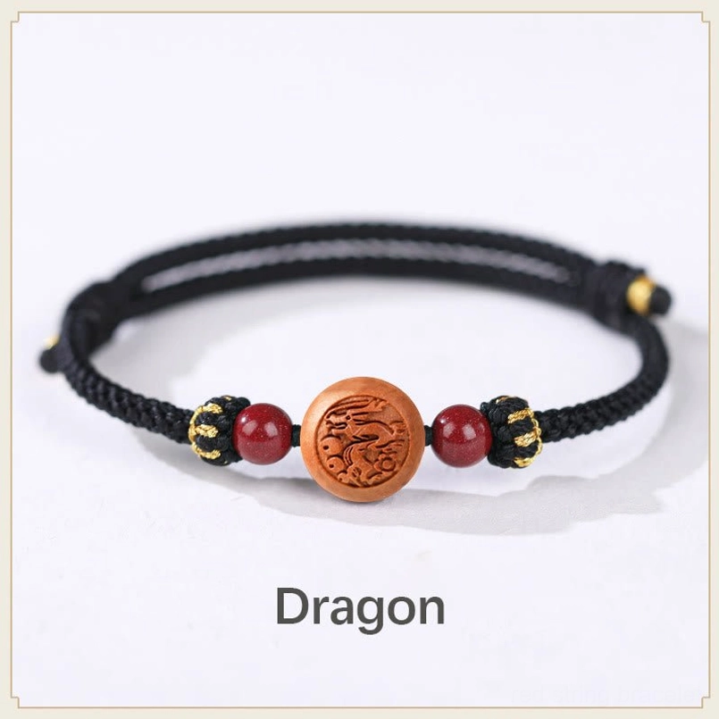 Dragon zodiac peach wood embossed bracelet black rope - intelligent ambitious fortune talisman