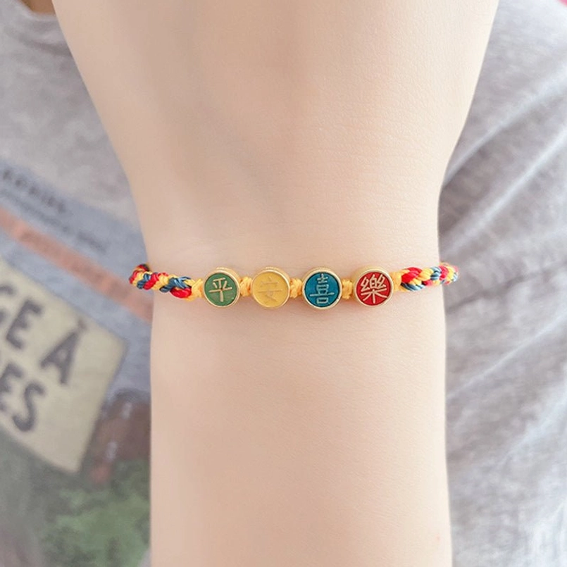 Dunhuang spiritual fortune bracelet on wrist showing tri-color woven cord and enamel character pendants