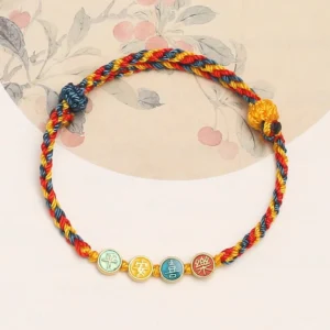 Dunhuang braided string bracelet with multicolor woven rope and enamel character pendants - top view