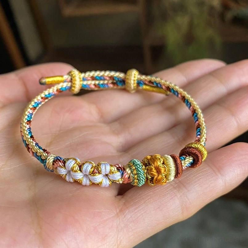 Dunhuang peach blossom braided bracelet worn on hand showing size and delicate woven details