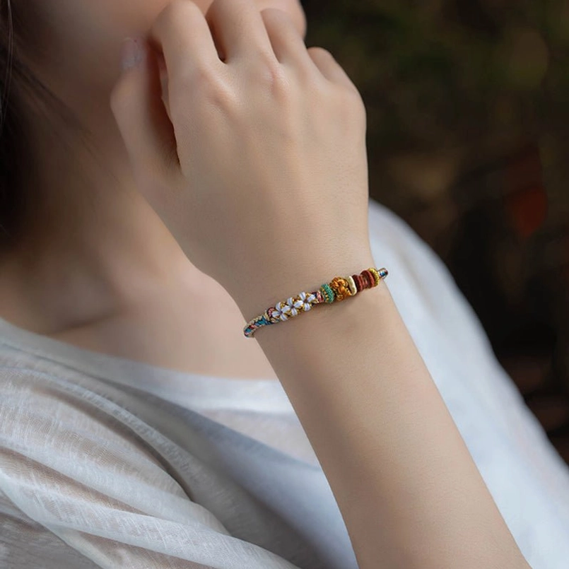 Multicolor Dunhuang peach blossom braided bracelet showing symbolism of renewal and natural beauty