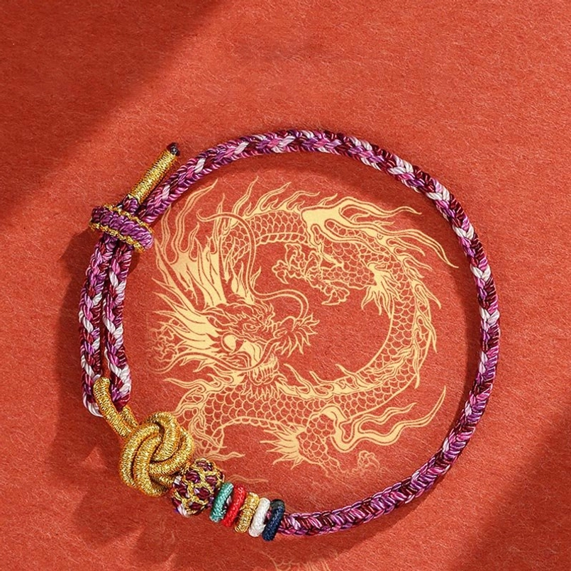 Purple handwoven protection bracelet with colorful beads and golden hand-tied knot detail