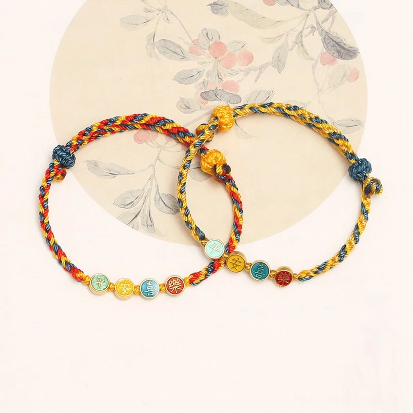 Pair of matching Dunhuang protection bracelets with colorful braided cords and spiritual charms