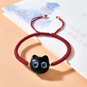 Ebony wood cat charm red string bracelet with wine red cord and adjustable knot on Chinese book