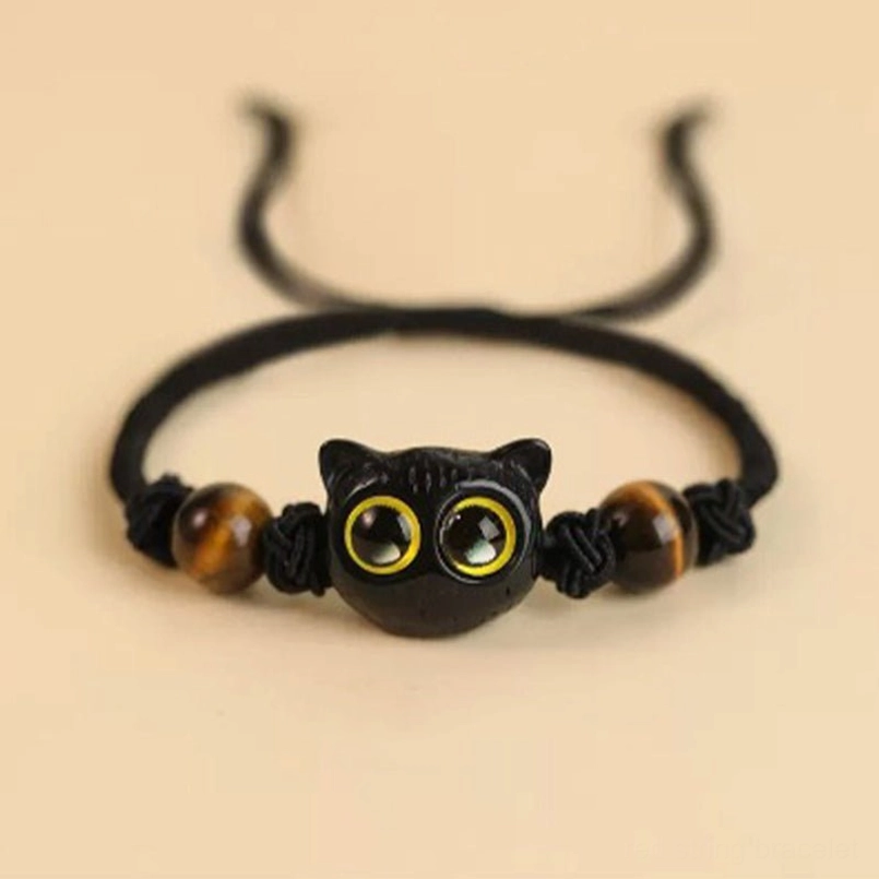 Ebony cat head red string bracelet bodhi seed accent close up