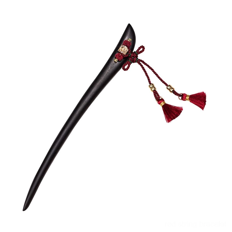 Ebony tassel hairpin flat lay with double red tassels Chinese knot