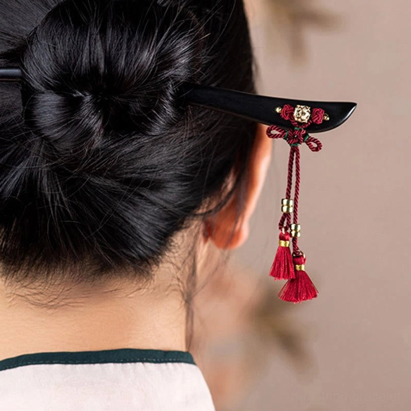 Ebony tassel hairpin spiritual protection symbol close-up detail