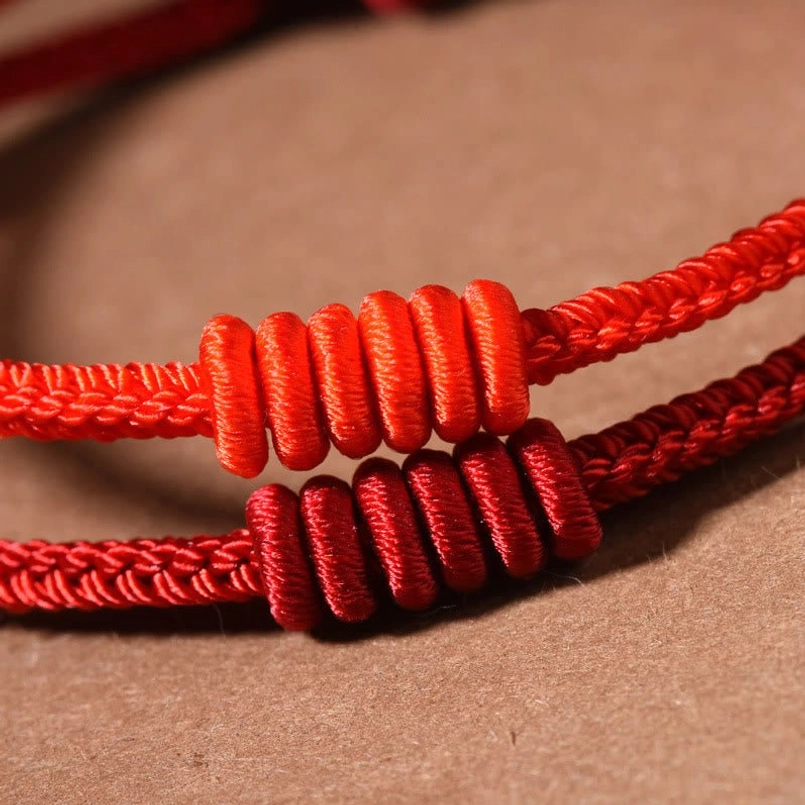 Eight stranded red string bracelet close up detail shot