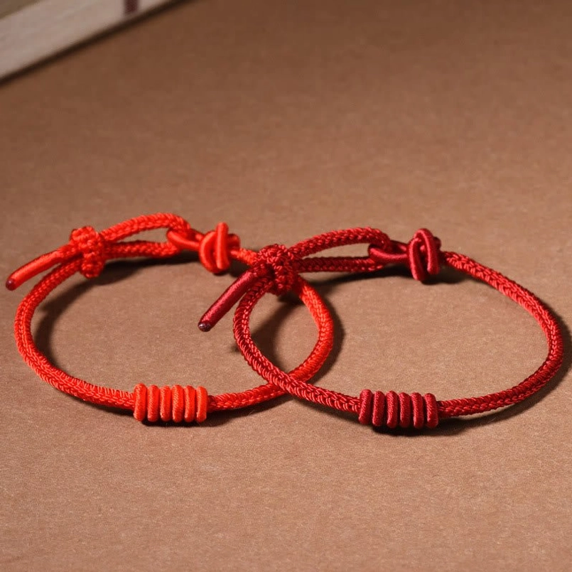 Eight stranded red string bracelet gifting scene display