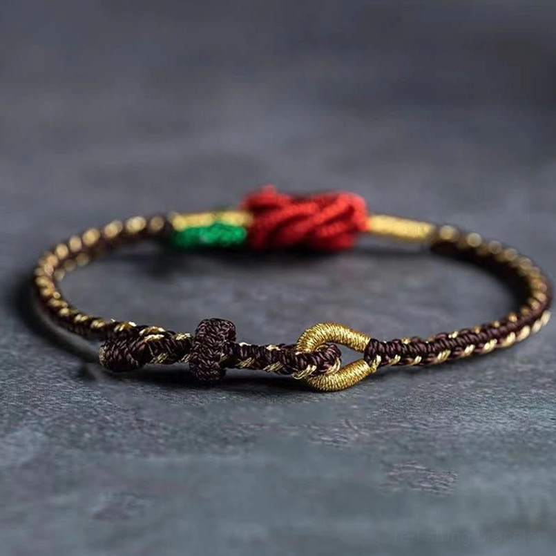 Tibetan eight thread peace knot lucky bracelet with red central knot and toggle clasp detail