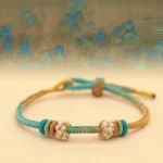 eight thread peace knot braided luck bracelet teal gold-brown with flower beads traditional design