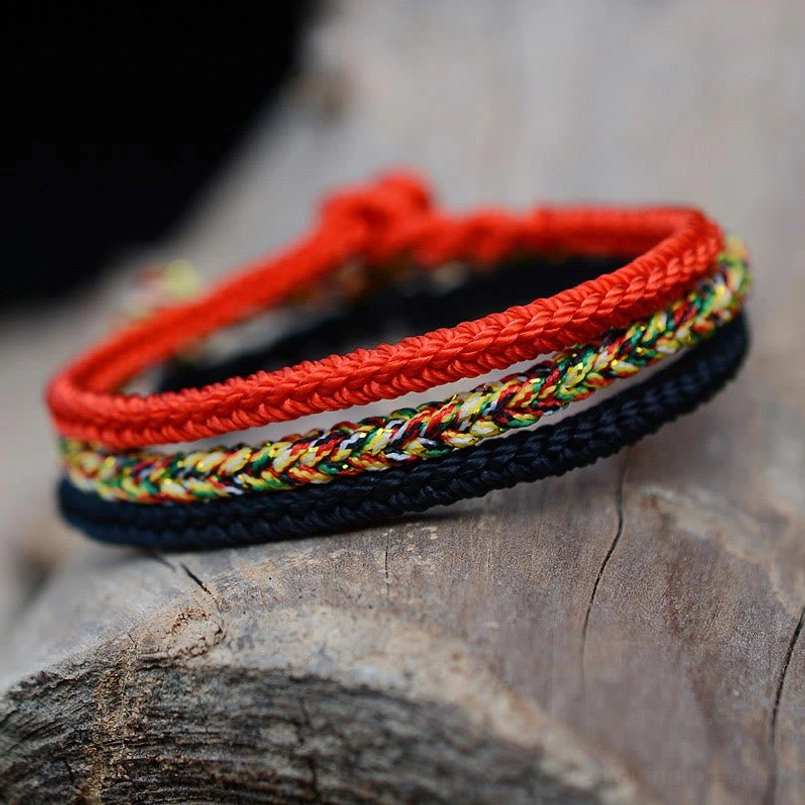 Handmade red and multicolor eight thread braided string bracelets stacked display