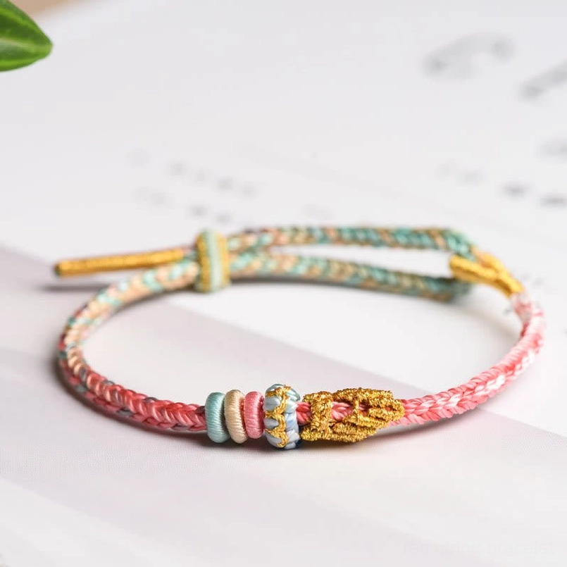 Cyan and pink colorful peace knot bracelet showing Tibetan Buddhist lucky charm design