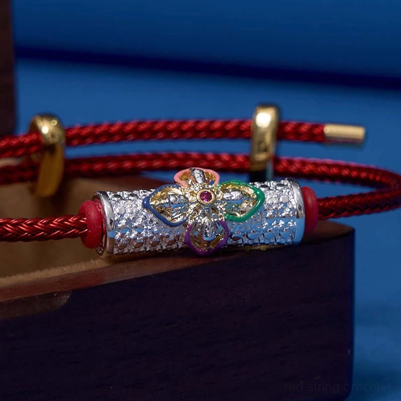 Side view of ornate enamel floral charm showing intricate design and colored petals