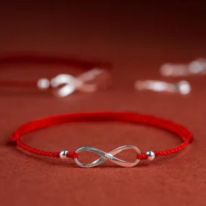 925 sterling silver endless knot red string bracelet side view on wine red background