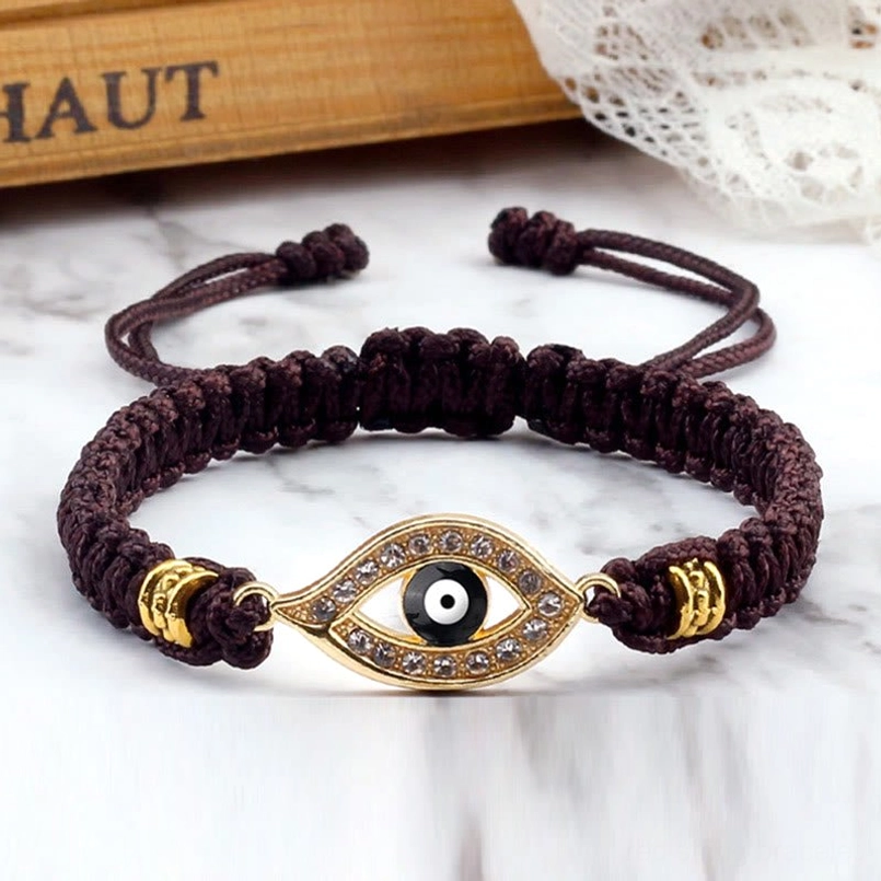 Brown cord evil eye red string bracelet with gold tone accent and rhinestone emboss
