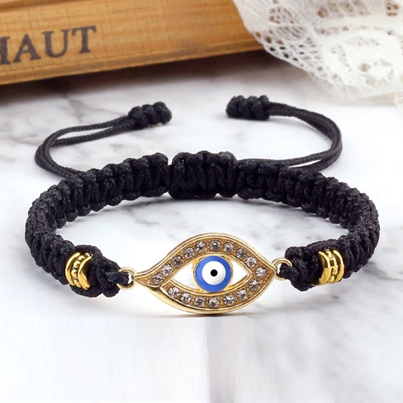 Purple pink evil eye charm with silver border on red woven string