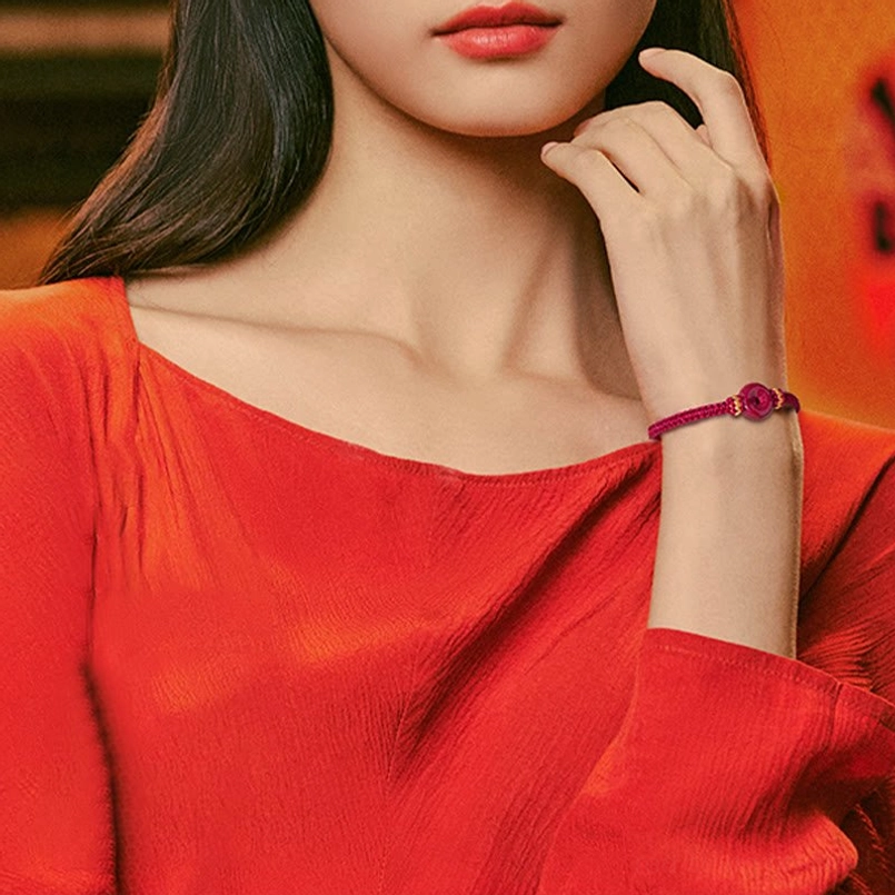 Female model wearing cinnabar peace buckle bracelet on left wrist