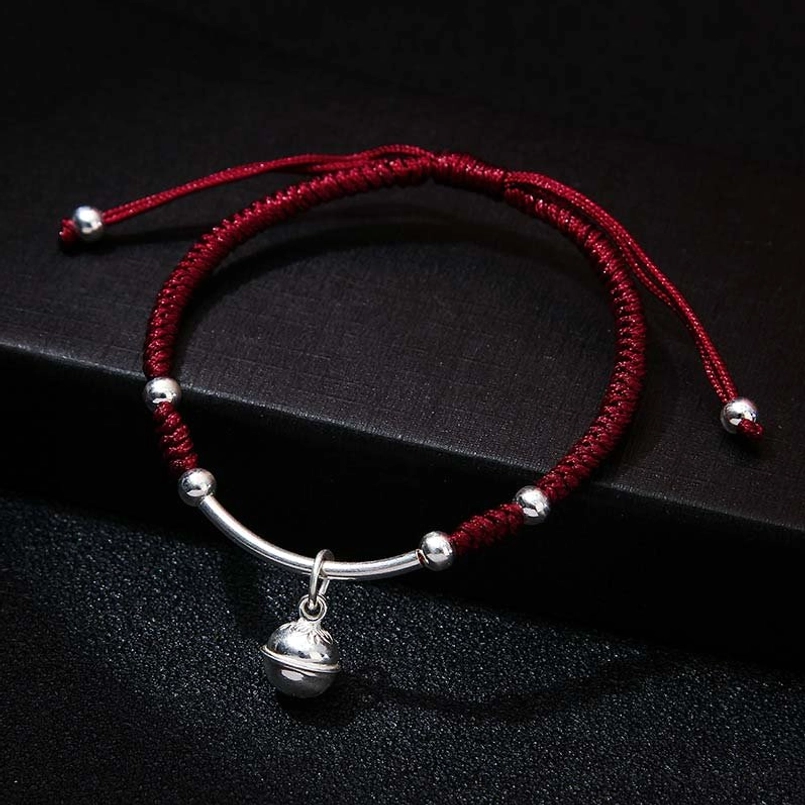 Deep red feng shui string bracelet with curved silver bar and bell charm