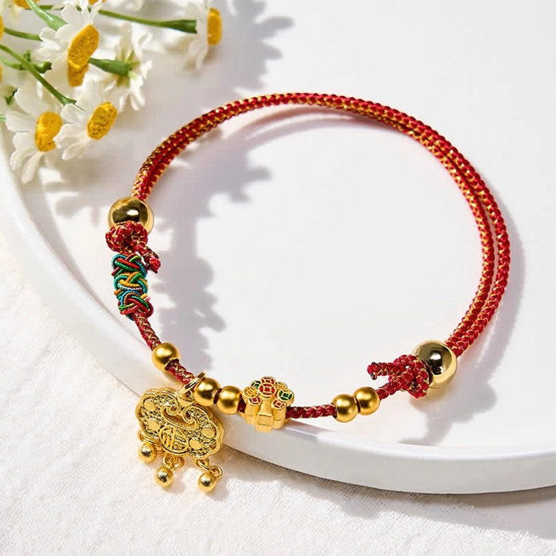 Festive red string cat dog collar with fu character and gold spherical beads on white plate