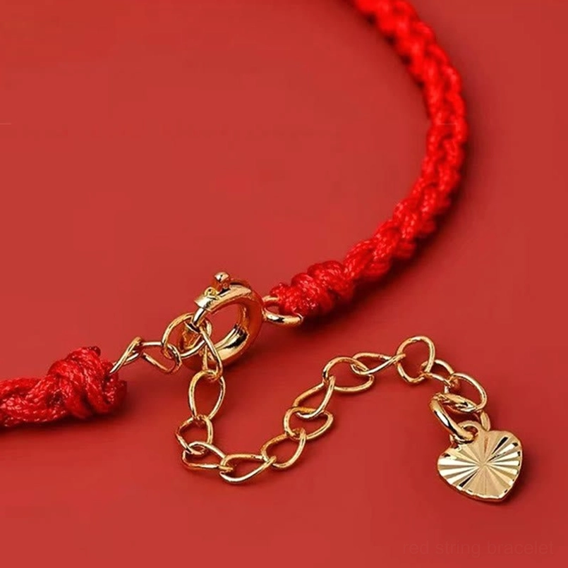 five colored enamel charms of five jambhalas red string bracelet detail shot
