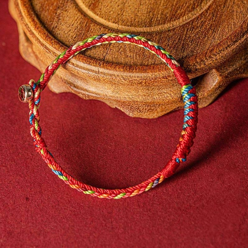 Handmade five color braided protection bracelet showing twisted braiding texture and metal adjustable buckle detail
