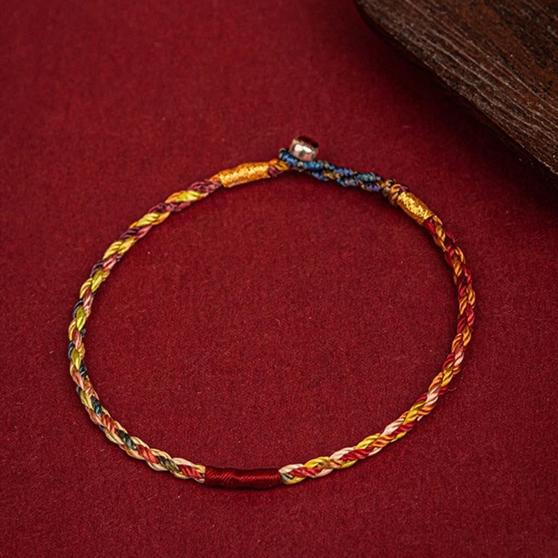 Handmade multicolor luck bracelet with neat braided design and silver metal clasp - oblique view