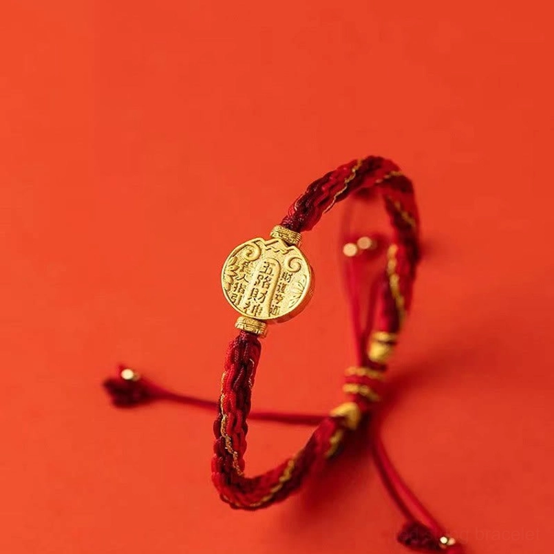 Five directions wealth bracelet front side view with detailed display of braided red-gold rope and round gold plaque
