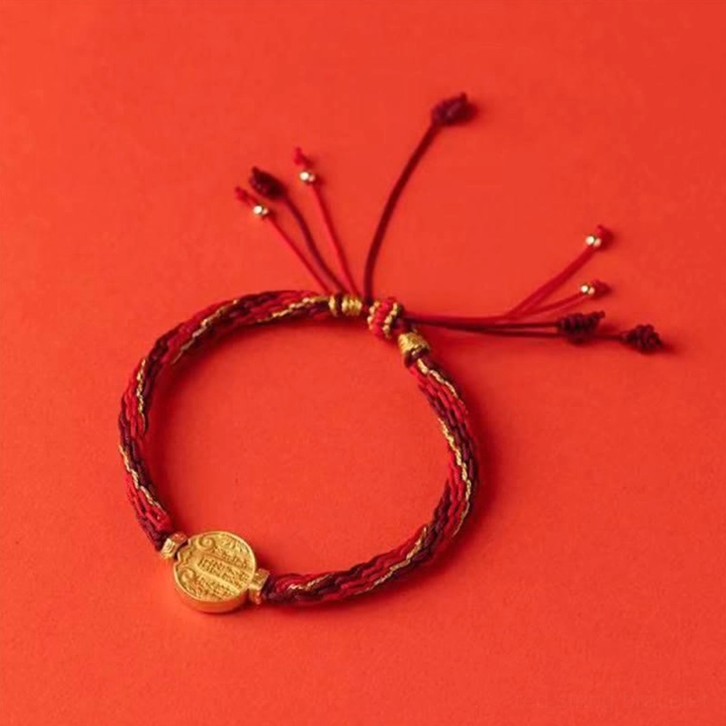 Complete five directions wealth red string bracelet flat lay showing full length with multi-strand tassels and gold accents