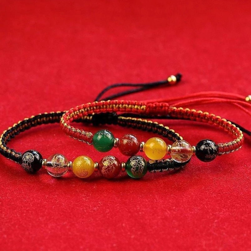 Pair of Five Directions wealth bracelets in black and red cord with matching five-bead fortune design