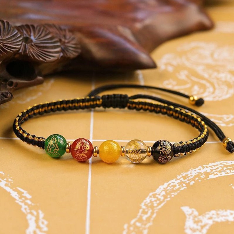 Traditional Five Directions protection bracelet flat lay featuring black woven cord and five colored fortune beads
