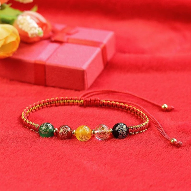 Red woven Five Directions luck bracelet with polished gemstones and sliding knot design