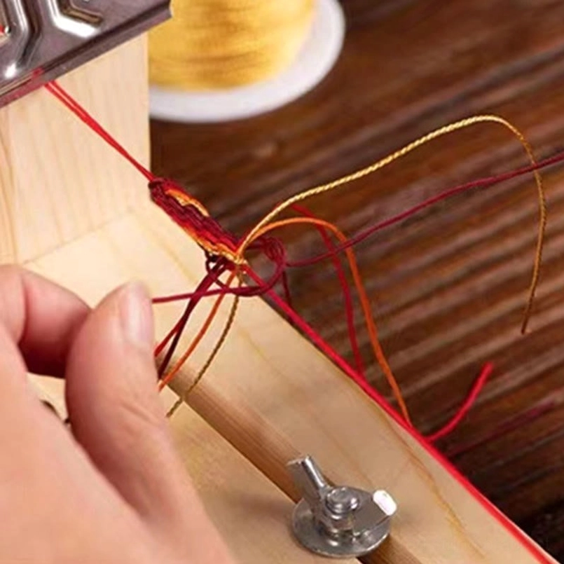 Red string wealth bracelet reincarnation knot sacred symbol detail showing intricate weaving pattern