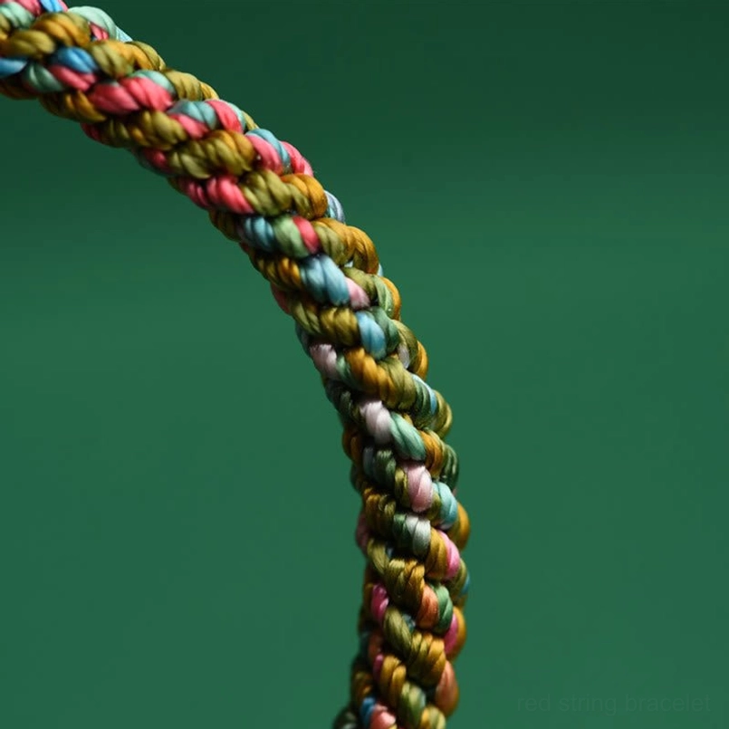 Extreme close-up macro view of thick twisted multicolor braid texture in five element lucky bracelet