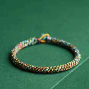 Multicolor five element braided rope bracelet with golden woven knot and turquoise bead accent, handcrafted luck charm