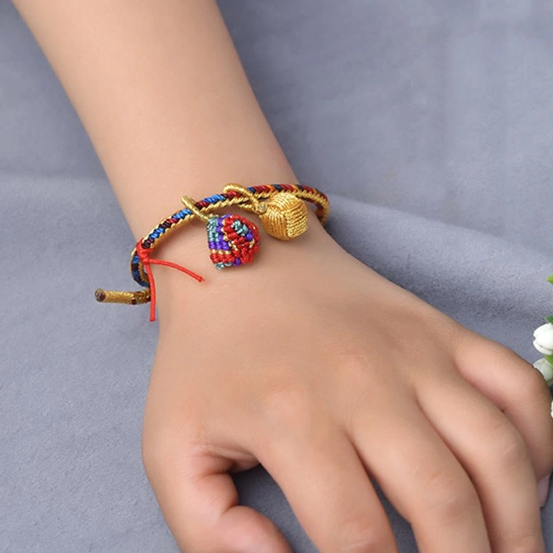 Five element multicolor braided red string bracelet worn on wrist side angle view