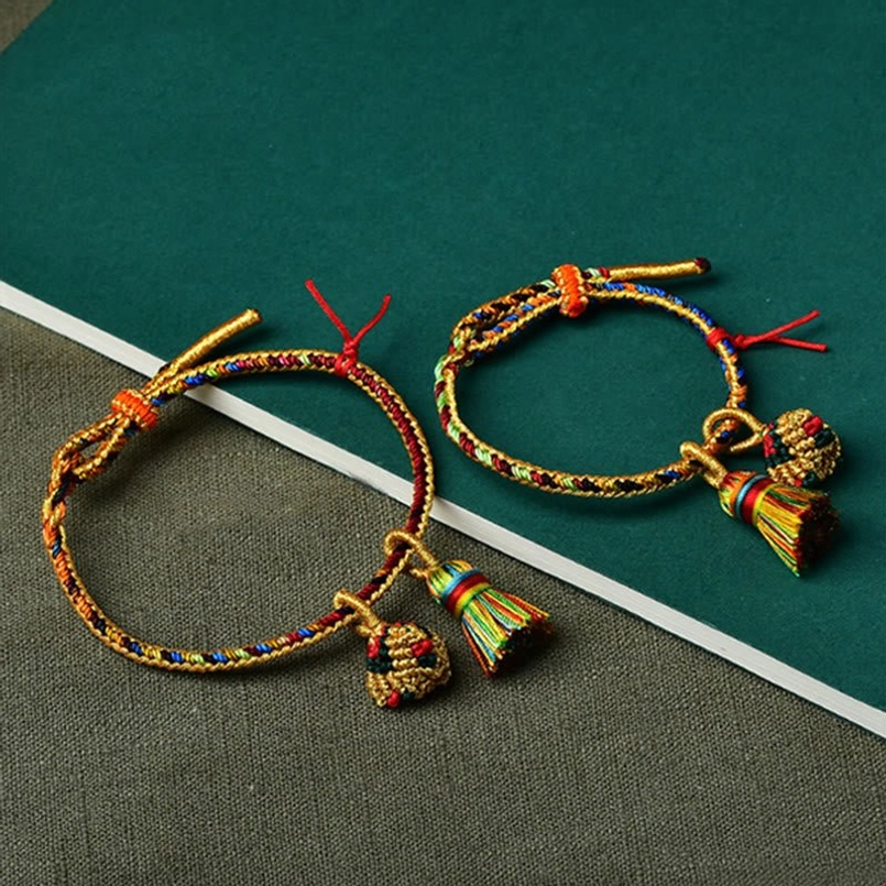 Two matching handmade five element colorful red string bracelets with golden ball charms