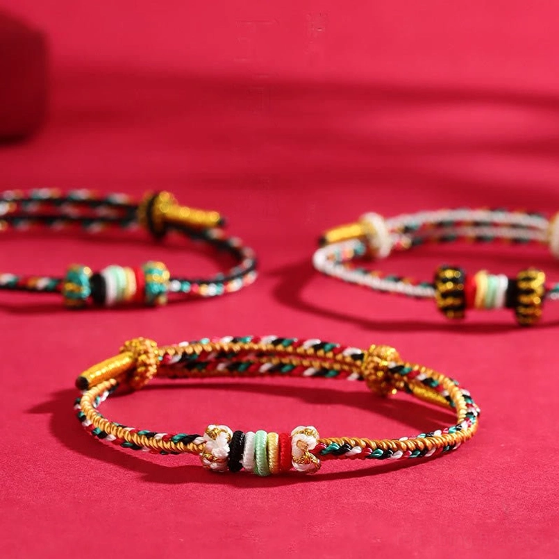 Multiple five elements feng shui lucky bracelets displayed together showing diverse color combinations with golden knots and beads