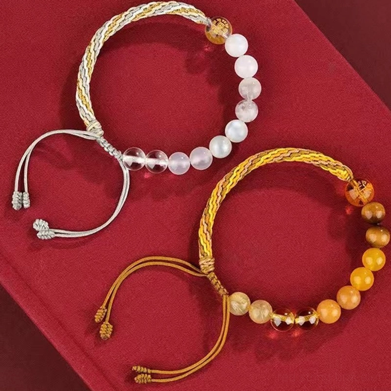 Two pairs of five elements reincarnation knot bracelets with adjustable tabs on velvet background