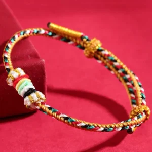 Five Elements Wuxing braided string bracelet with colorful reef knot and completeness knot design on red velvet background