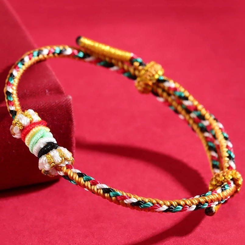 Five Elements Wuxing braided string bracelet with colorful reef knot and completeness knot design on red velvet background