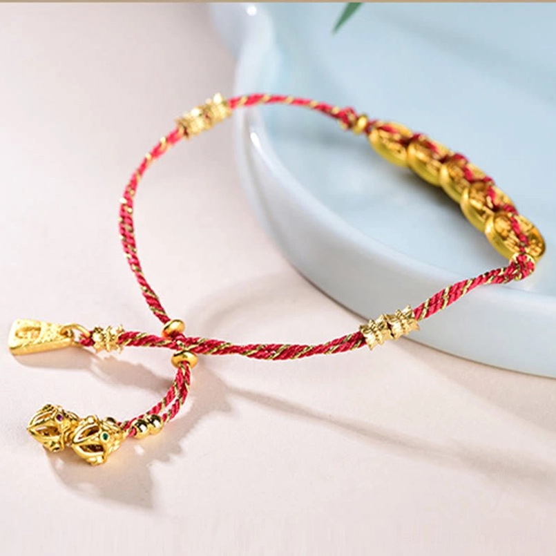 Oblique angle of woven red rope bracelet with pull-adjustable buckle and tassel decorations