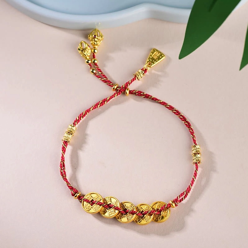 Flat lay top view of Five-Emperor Coins red string bracelet with tassel adjustable ends