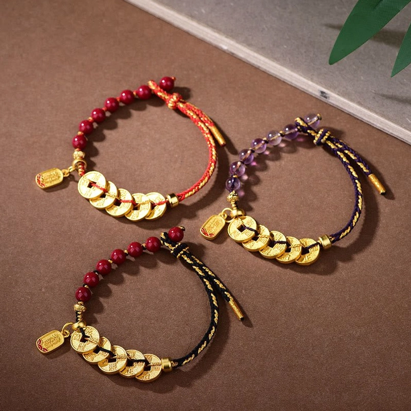 Red string bracelet five emperor coins close-up handmade artisan crafted