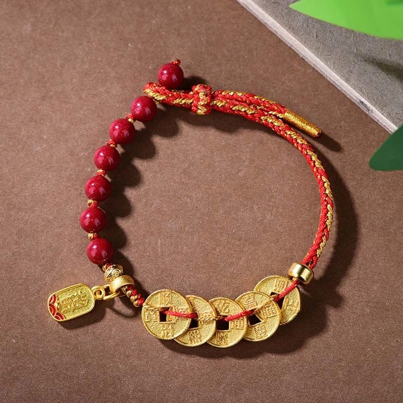Five-emperor coins red string bracelet with cinnabar beads copper coins flat lay