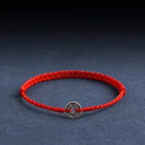 Five Emperor Coins red string bracelet front view with silver coin charm on braided red cord