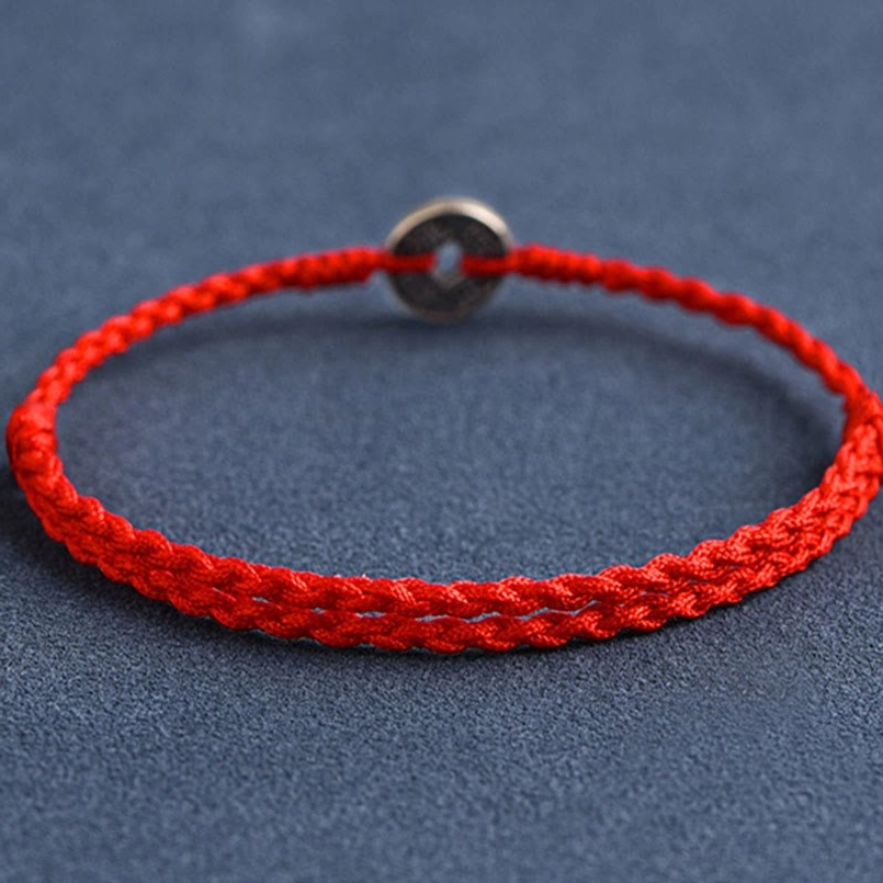 Three-quarter angle of Five Emperor Coins red string jewelry with braided rope and silver coin detail