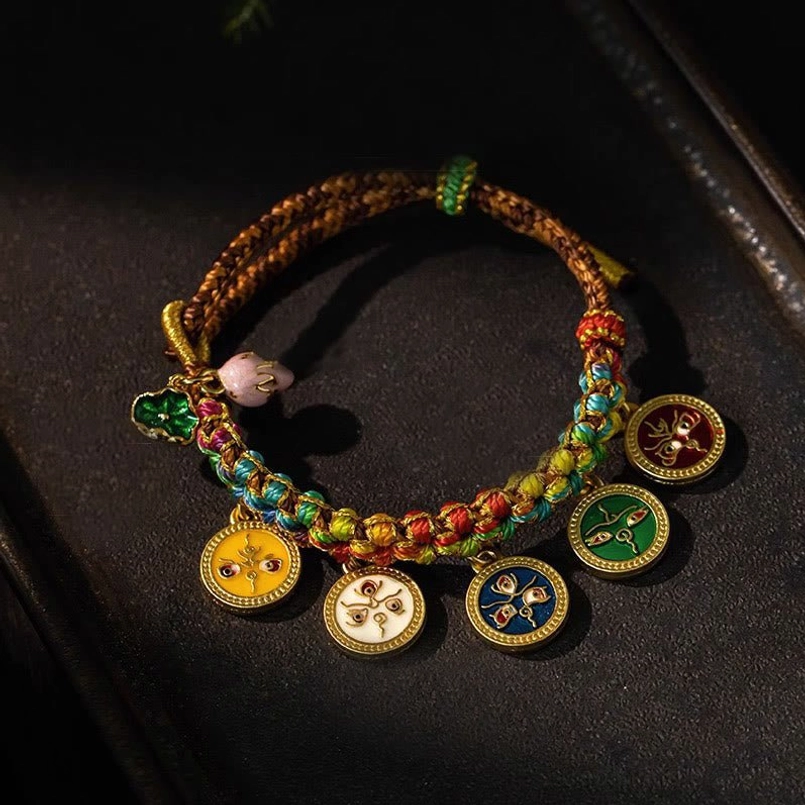 Five God of Wealth Tibetan multicolor braided rope bracelet with enamel pendants - top down flat lay