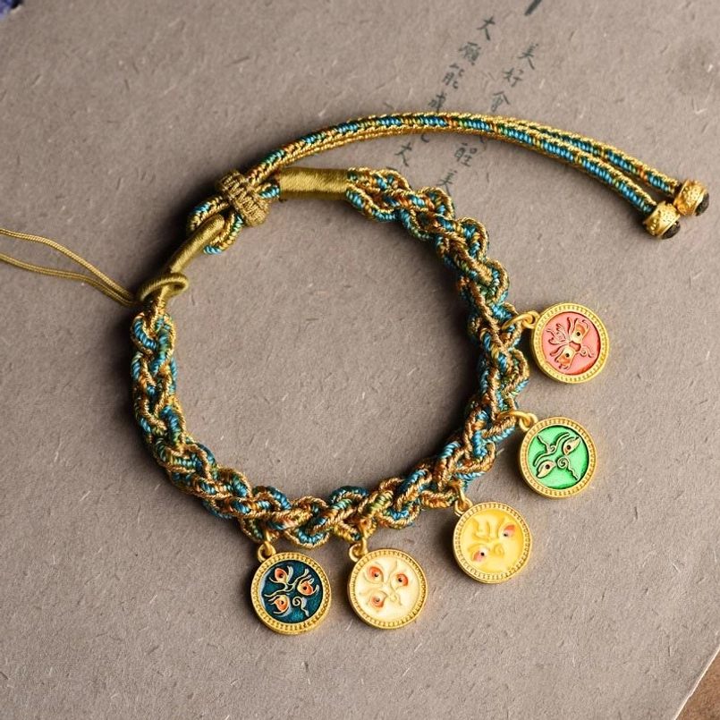 Five gods of wealth fortune bracelet flat lay showing all five enamel charm pendants