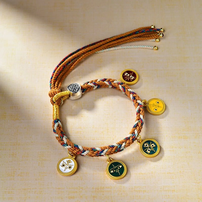 Five Gods of Wealth Tibetan multicolor rope bracelet with five enamel charms flat lay